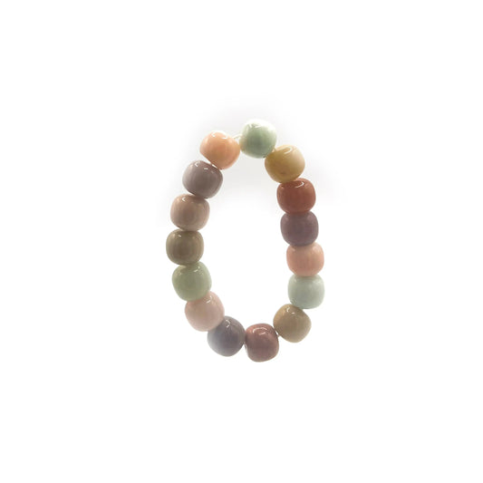 Colorful bracelet for sale featuring rainbow-toned golden silk jade beads, designed in a playful mochi donut style with an adjustable cord for all wrist sizes.