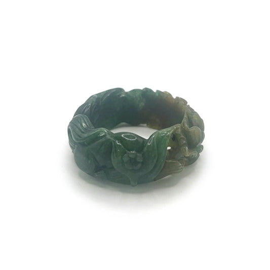 Carved jade bracelet in emerald Mongolian quartzite, featuring hand-carved peony and nine-tailed kitsune symbols with vibrant yellow detailing.