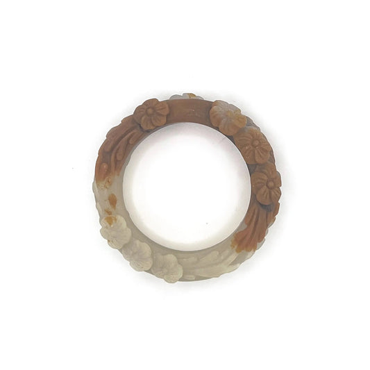 Carved jade bangle featuring three-dimensional floral motifs in warm caramel-colored Mongolian quartzite, hand-carved with an earthy and elegant finish.