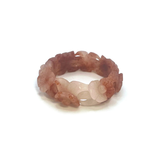 Bangle for small wrists featuring hand-carved cherry blossom motifs in vibrant red and translucent white natural stone with a hollowed, floral design.