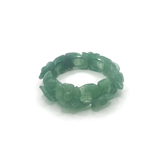 Hand-carved flower bangle bracelet in emerald green Mongolian jade, featuring delicate floral motifs and a hollow-carved design for lightness and elegance.