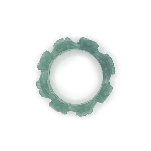 Hand-carved flower bangle bracelet in emerald green Mongolian jade, featuring delicate floral motifs and a hollow-carved design for lightness and elegance.