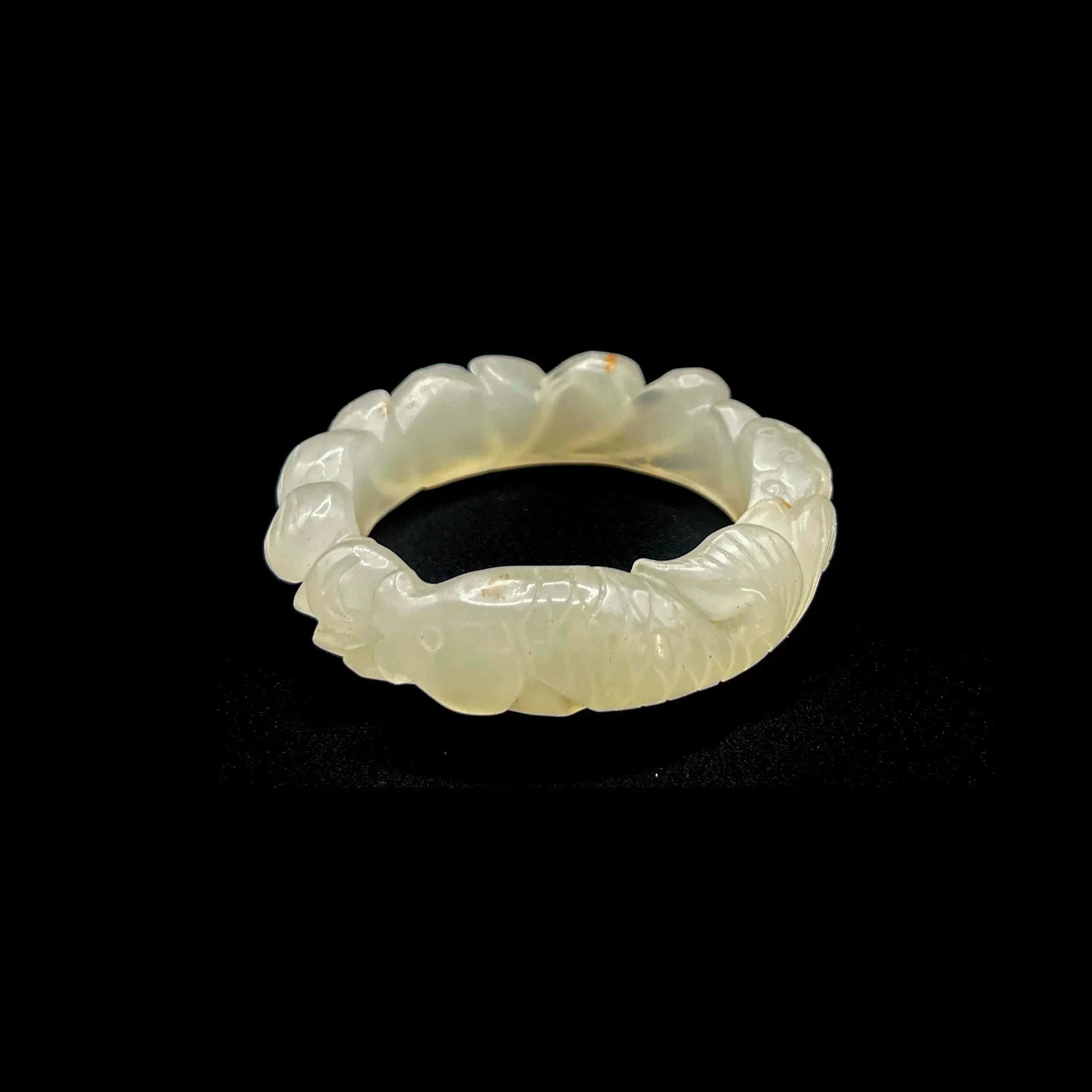 Hand-carved white jade lotus flower bracelet with koi fish motifs, symbolizing purity and prosperity.