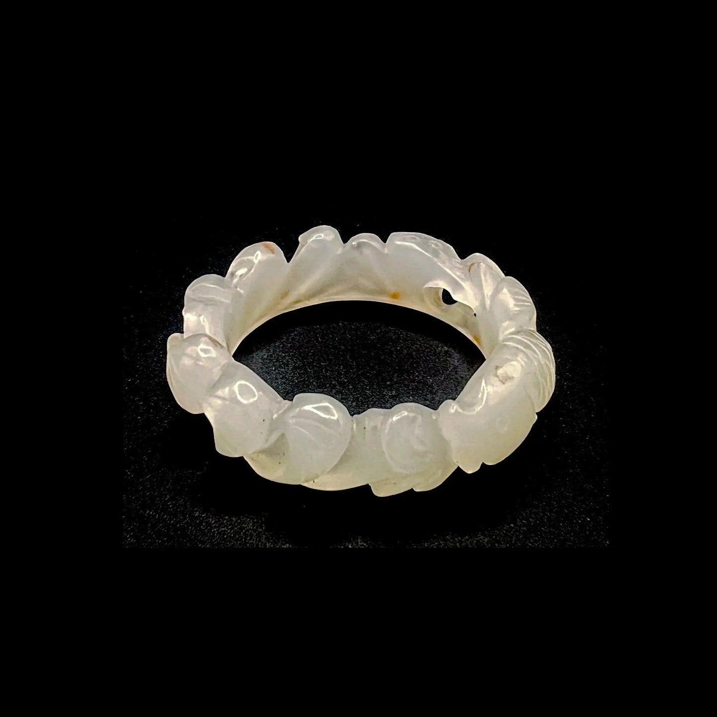 Hand-carved white jade lotus flower bracelet with koi fish motifs, symbolizing purity and prosperity.