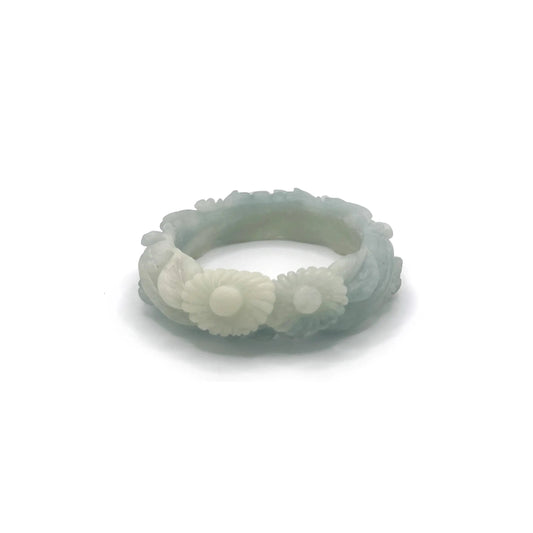 Hand-carved blue jade bangle with floral motifs including peonies and daisies, crafted from Mongolian quartzite in sky-blue and white hues.