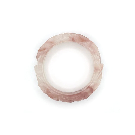 Natural jade bangle carved from pink Mongolian quartzite, featuring dual lotus flower designs symbolizing purity and serenity in a translucent finish.