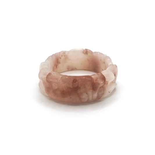 Natural jade bangle carved from pink Mongolian quartzite, featuring dual lotus flower designs symbolizing purity and serenity in a translucent finish.