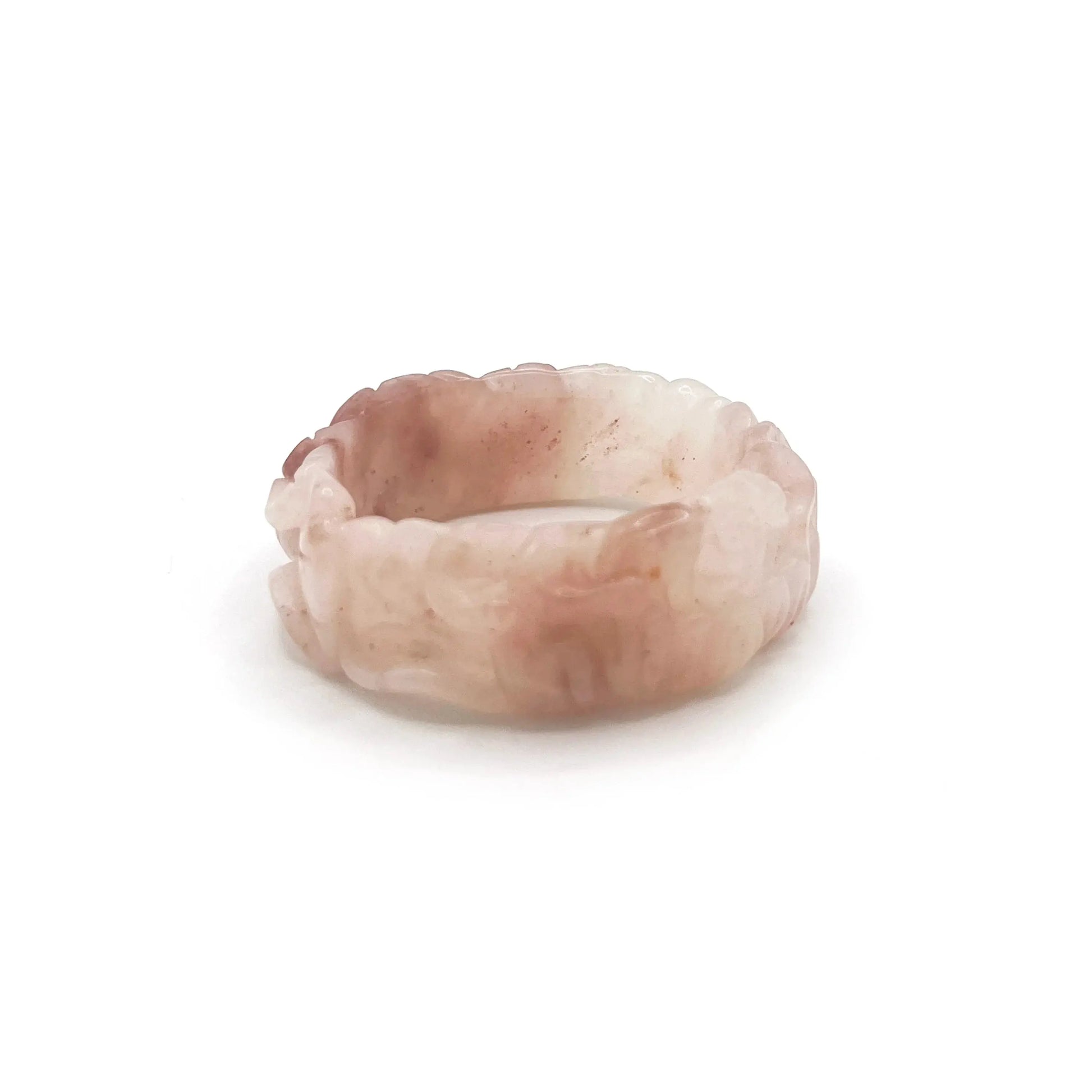 Natural jade bangle carved from pink Mongolian quartzite, featuring dual lotus flower designs symbolizing purity and serenity in a translucent finish.