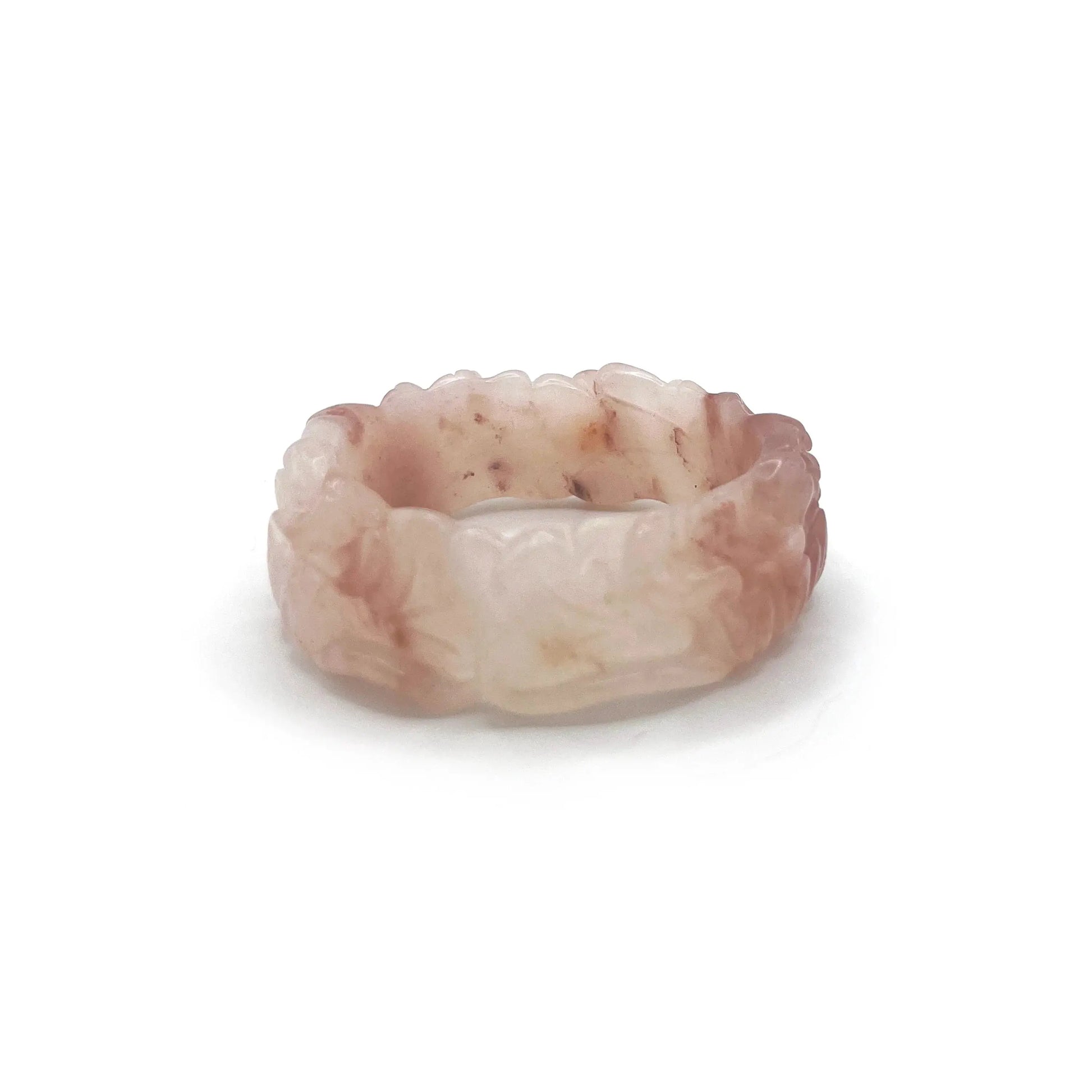 Natural jade bangle carved from pink Mongolian quartzite, featuring dual lotus flower designs symbolizing purity and serenity in a translucent finish.
