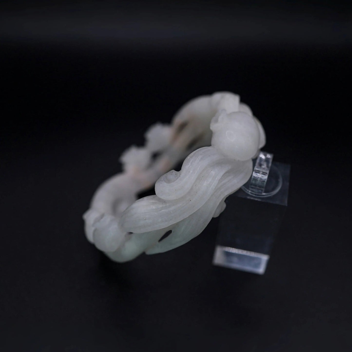 Translucent white jade bracelet with bluebell flowers and winding vine pattern in openwork