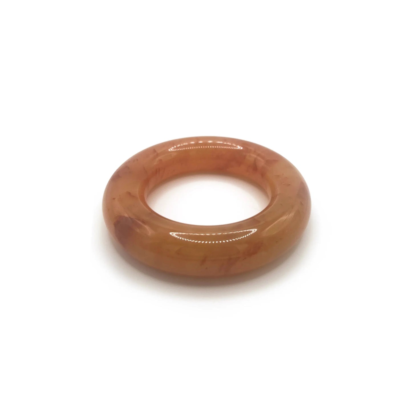Donut bangle bracelet carved from Mongolian jade quartzite in translucent orange, featuring red petal accents and a smooth, jelly-like round silhouette. - Miruzi