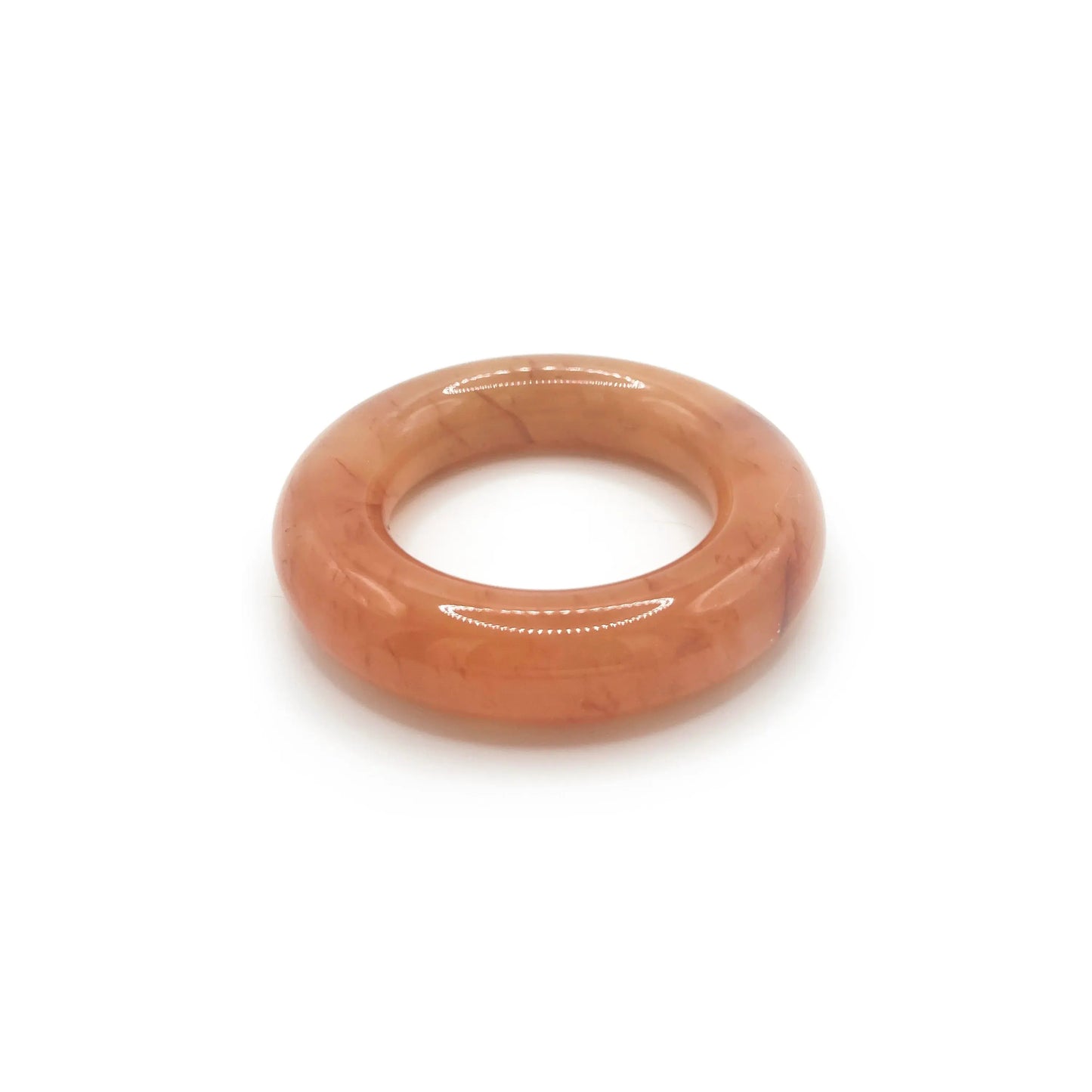 Donut bangle bracelet carved from Mongolian jade quartzite in translucent orange, featuring red petal accents and a smooth, jelly-like round silhouette. - Miruzi