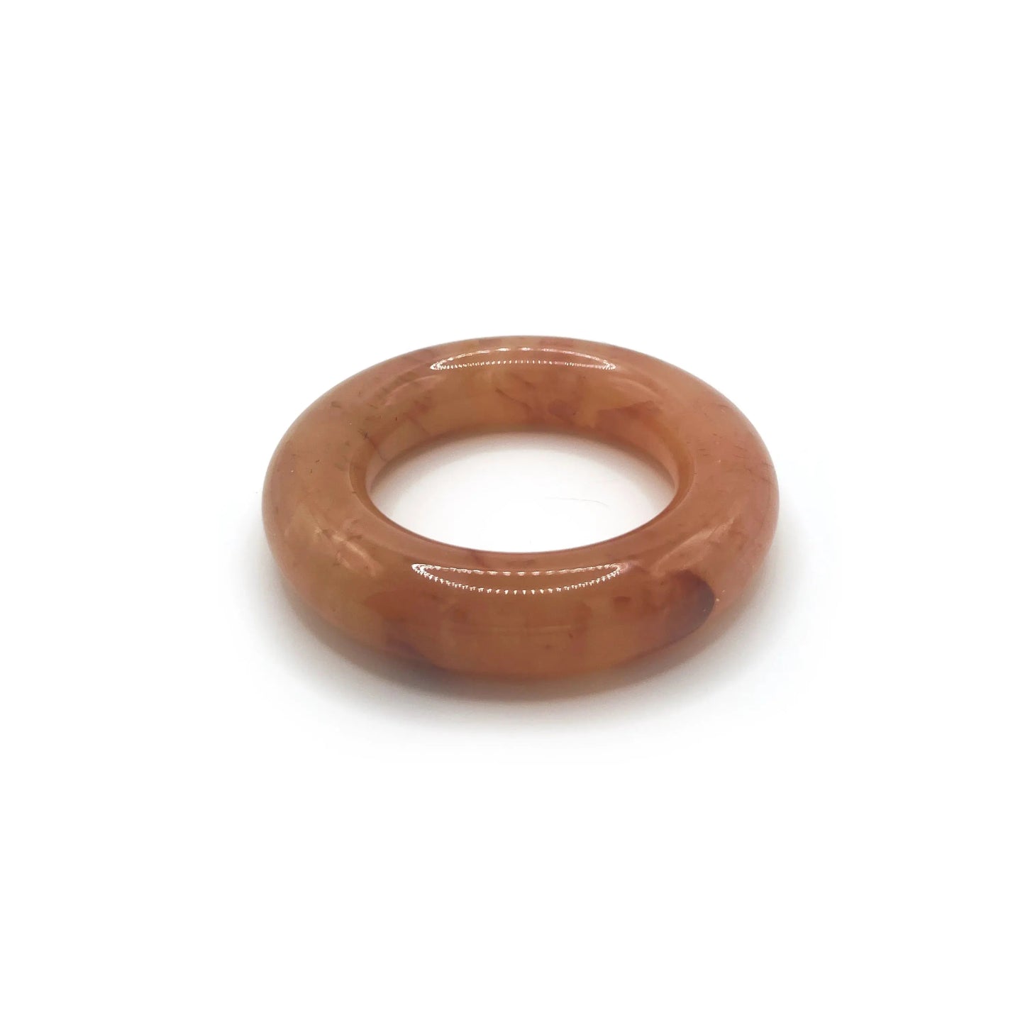 Donut bangle bracelet carved from Mongolian jade quartzite in translucent orange, featuring red petal accents and a smooth, jelly-like round silhouette. - Miruzi