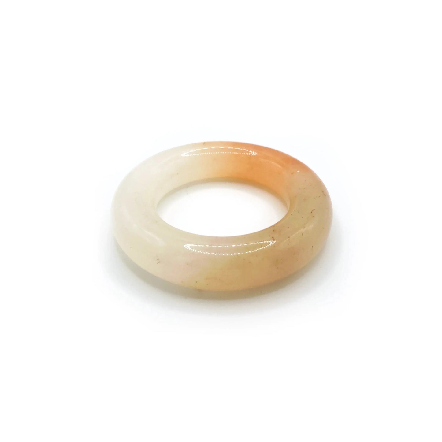 Donut bangle made from Mongolian jade featuring vibrant orange and white splashes, inspired by citrus soda with a playful, summer-ready design. - Miruzi