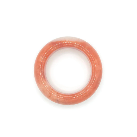 Orange jade bangle bracelet featuring a vibrant orange base, clear quartzite contrast, and red and black floral motifs inspired by falling autumn leaves.