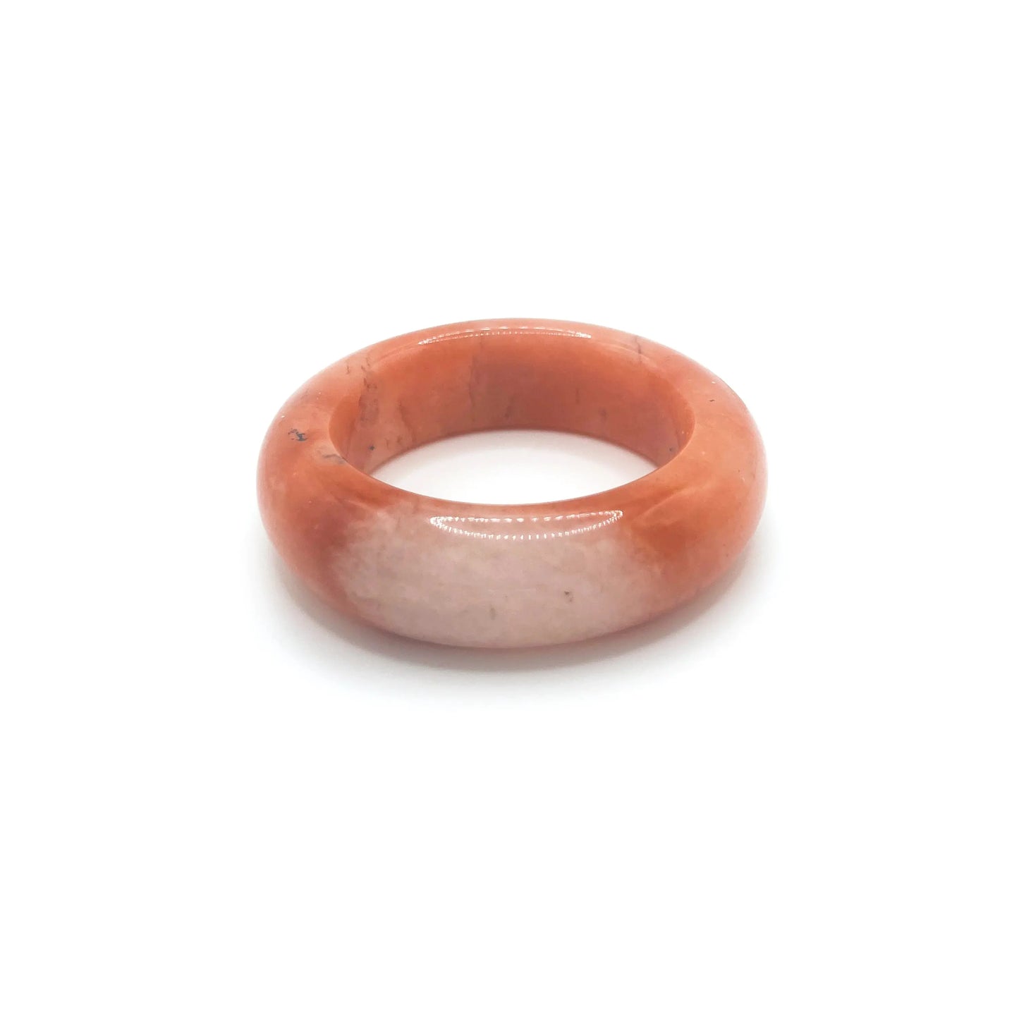 Orange jade bangle bracelet featuring a vibrant orange base, clear quartzite contrast, and red and black floral motifs inspired by falling autumn leaves.
