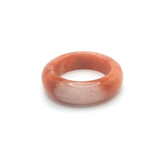 Orange jade bangle bracelet featuring a vibrant orange base, clear quartzite contrast, and red and black floral motifs inspired by falling autumn leaves.