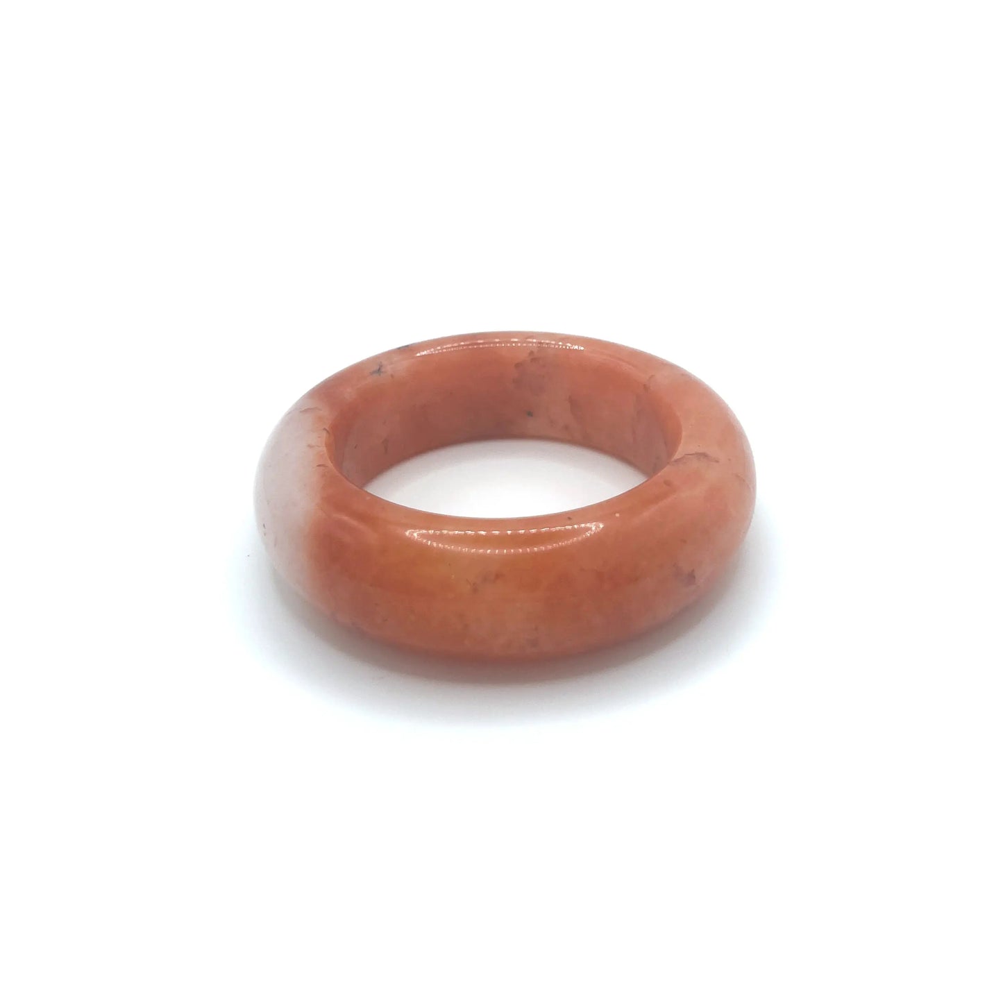 Orange jade bangle bracelet featuring a vibrant orange base, clear quartzite contrast, and red and black floral motifs inspired by falling autumn leaves.