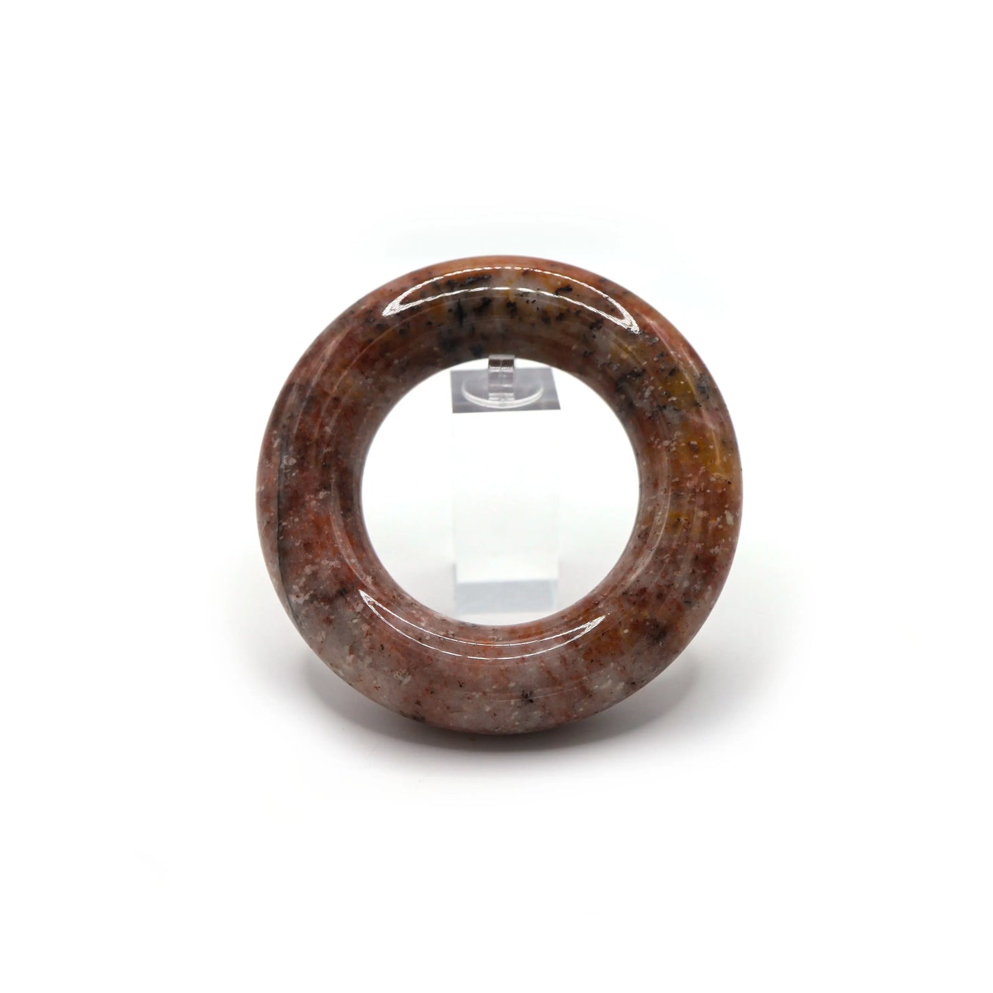 Round pink jade bangle with expressive mineral patterns flowing across the surface, evoking motion and creative freedom – Miruzi