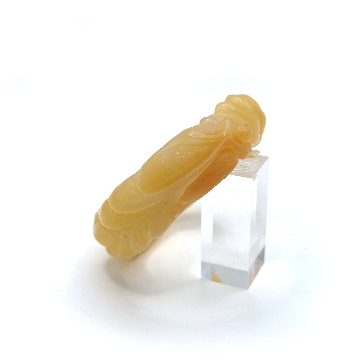 A soft golden jade bracelet with delicately sculpted lotus petals and goldfish, offering a peaceful yet energetic symbolism – Miruzi