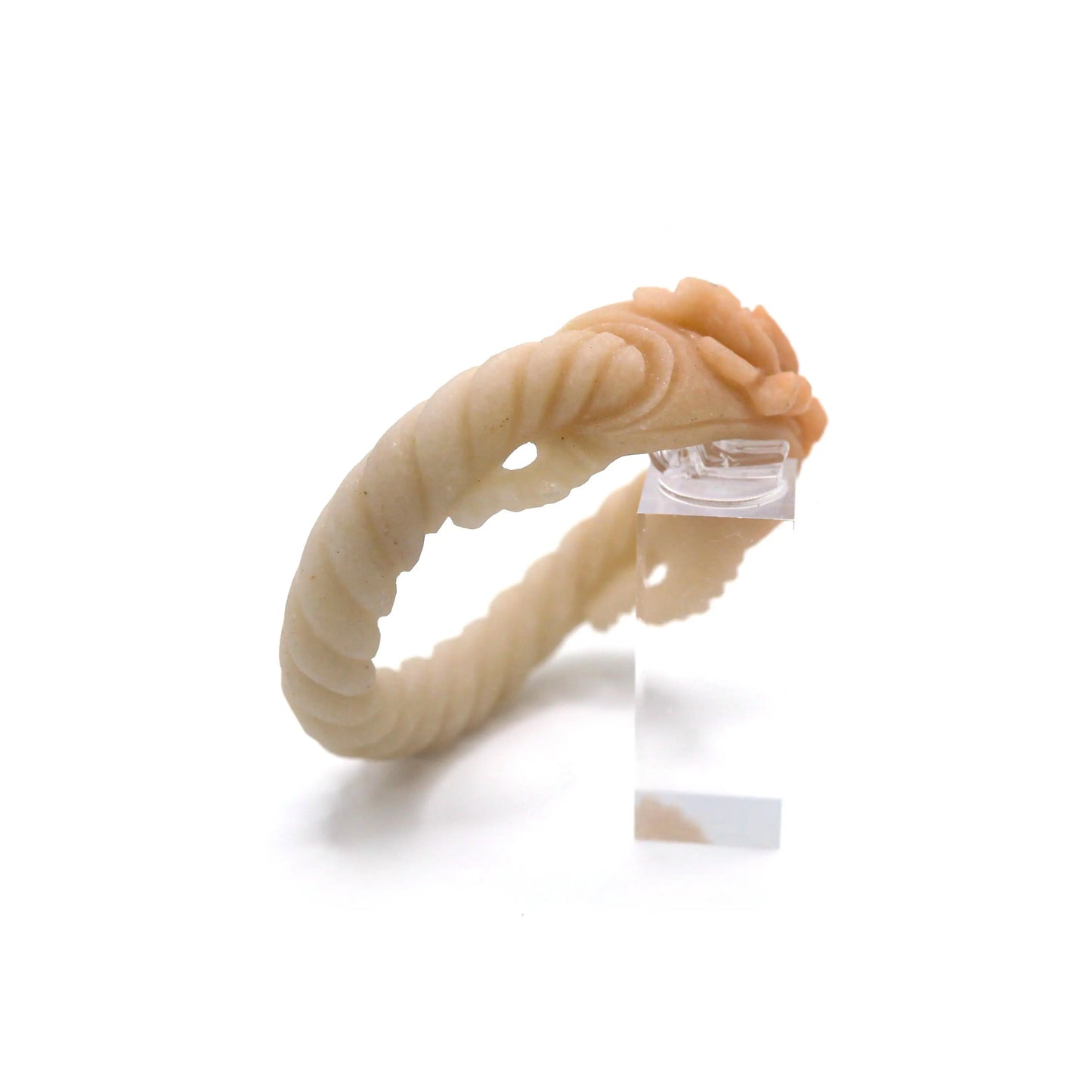A twisted arc of pale jade flows into a raised peony carving in warm caramel jade, creating a bracelet of natural depth and artistry – Miruzi