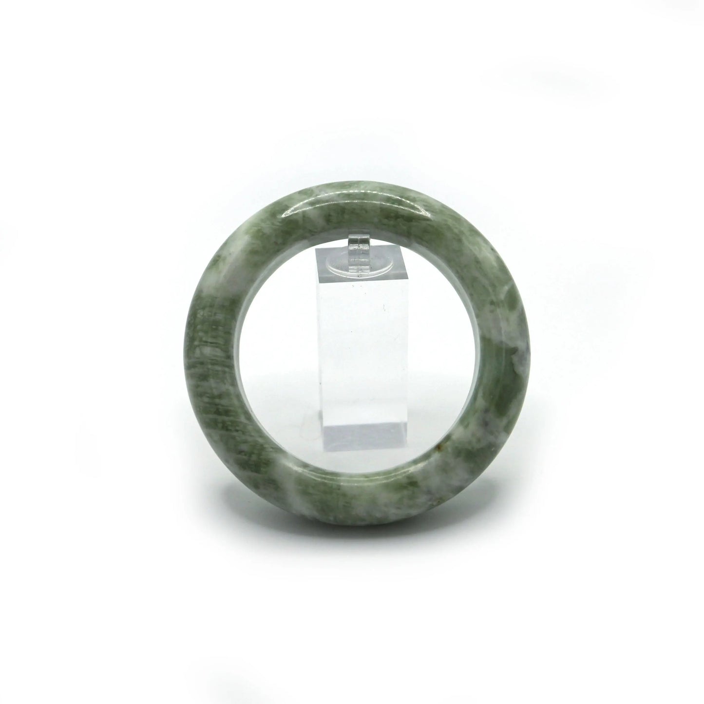 Light matcha jade bangle placed in soft jewelry pouch for safe storage - Miruzi