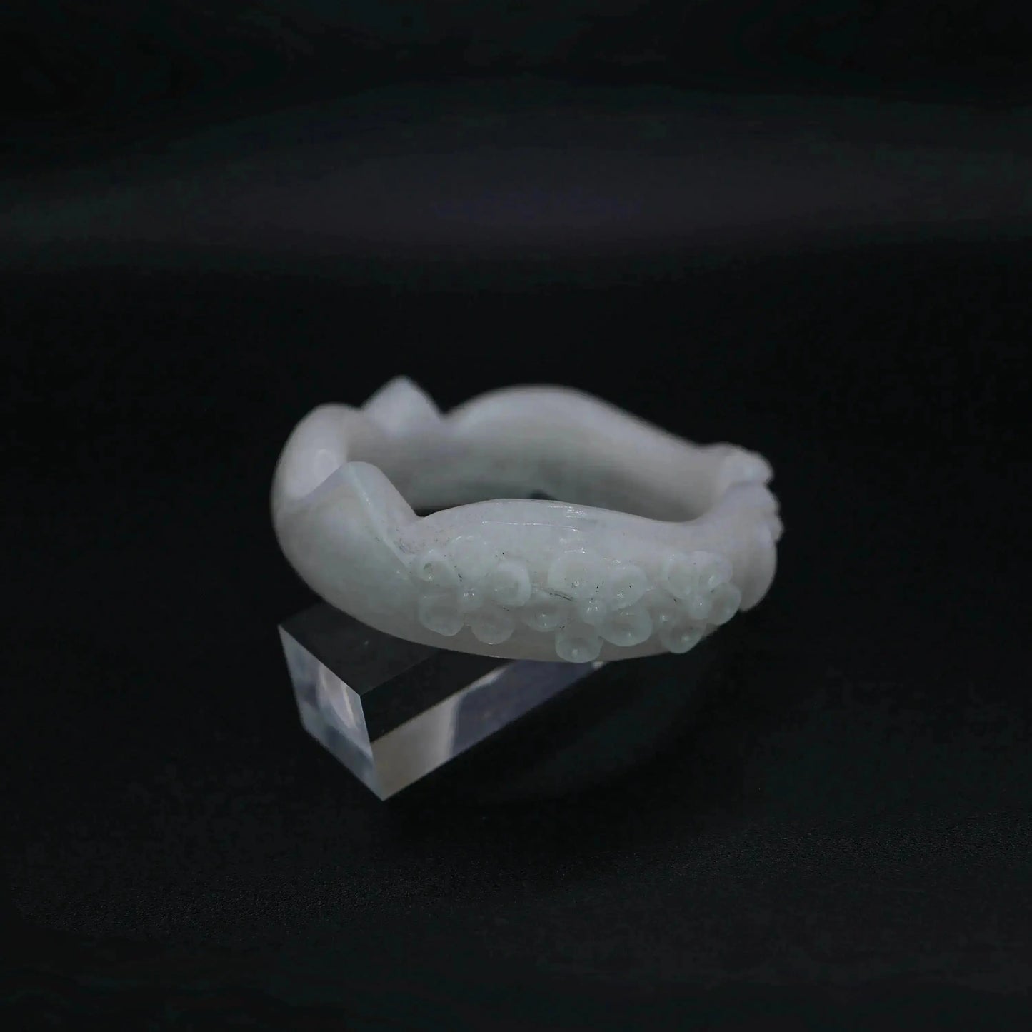 A sculptural white jade bracelet featuring refined feline and floral details in a full-circle, hand-polished silhouette – Miruzi