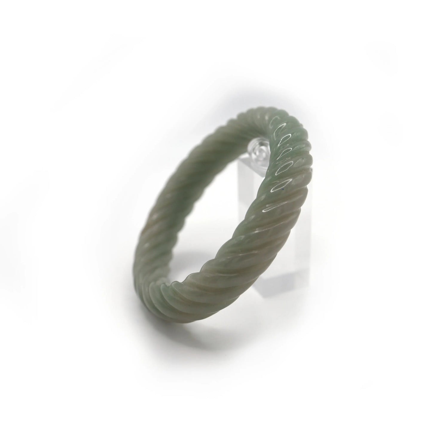 Twisted green jade bracelet featuring graceful motion and two coin-shaped carvings, blending form and tradition – Miruzi