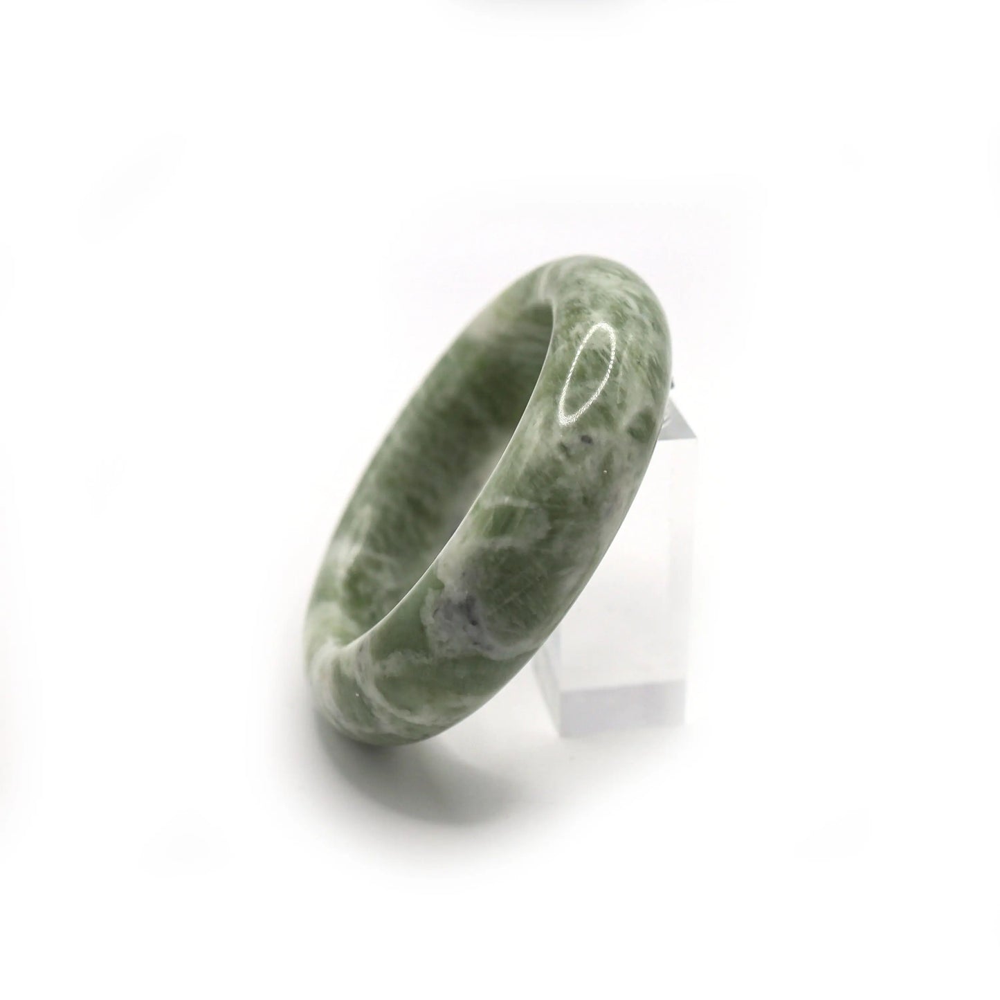 Close-up of creamy jade bracelet showing swirls of white mineral veining - Miruzi