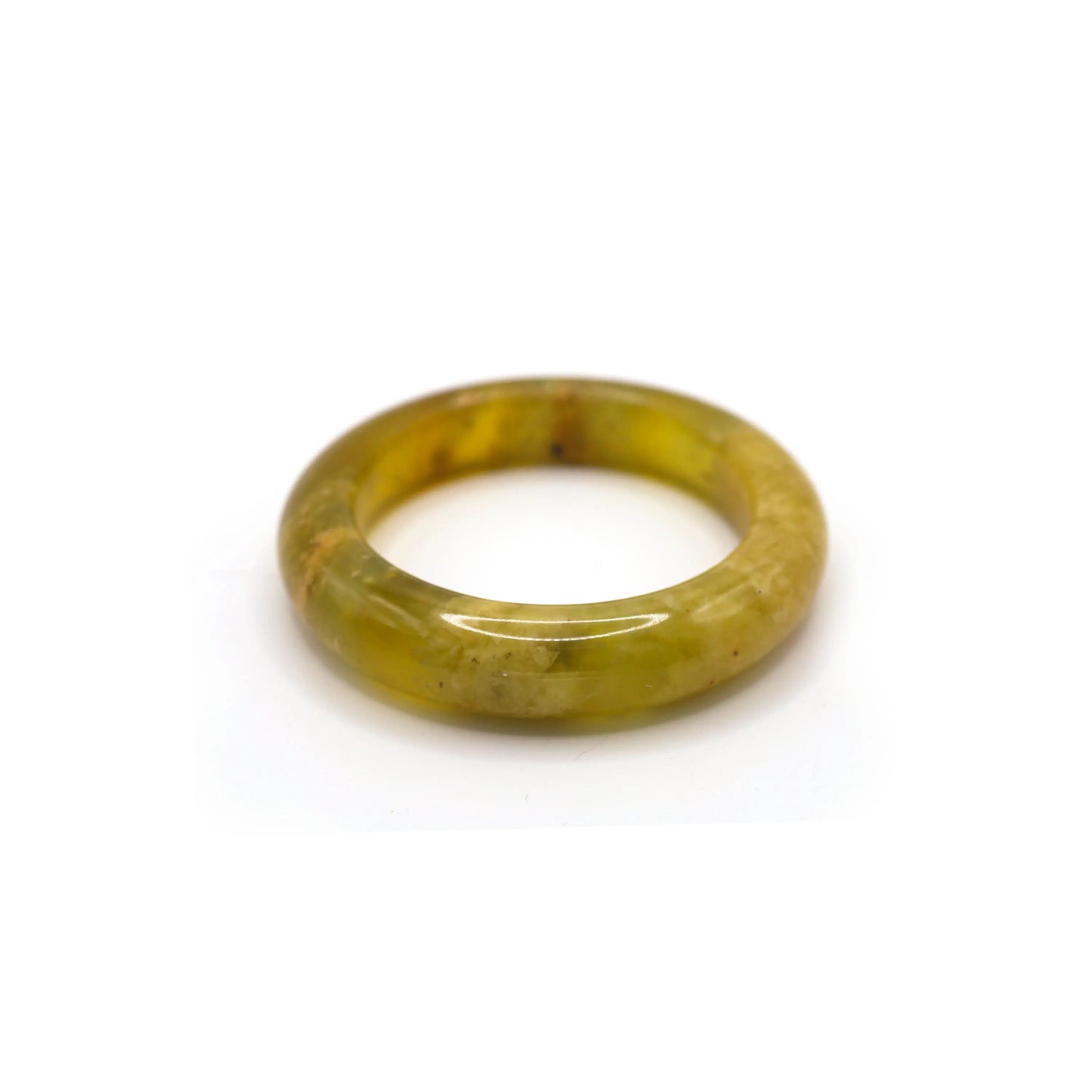 Yellow serpentine jade bracelet resting on a neutral-toned cloth, showcasing fine botanical patterns and a smooth, ice-like surface. - Miruzi