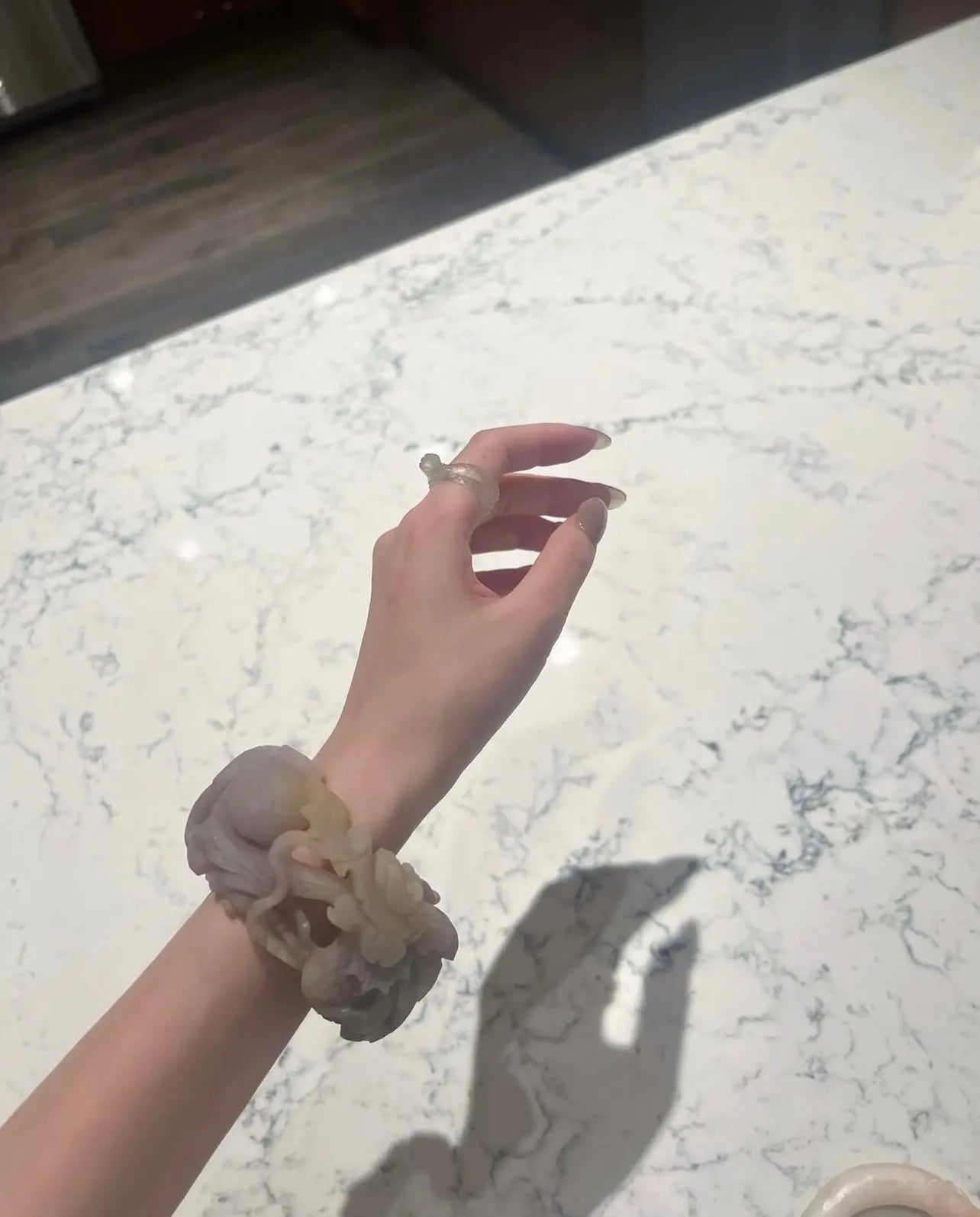 Artistic fine jewelry jade bangle featuring a hand-carved dragon chasing a pearl, in purple and golden Mongolian quartzite—symbolizing prosperity and strength. - Miruzi