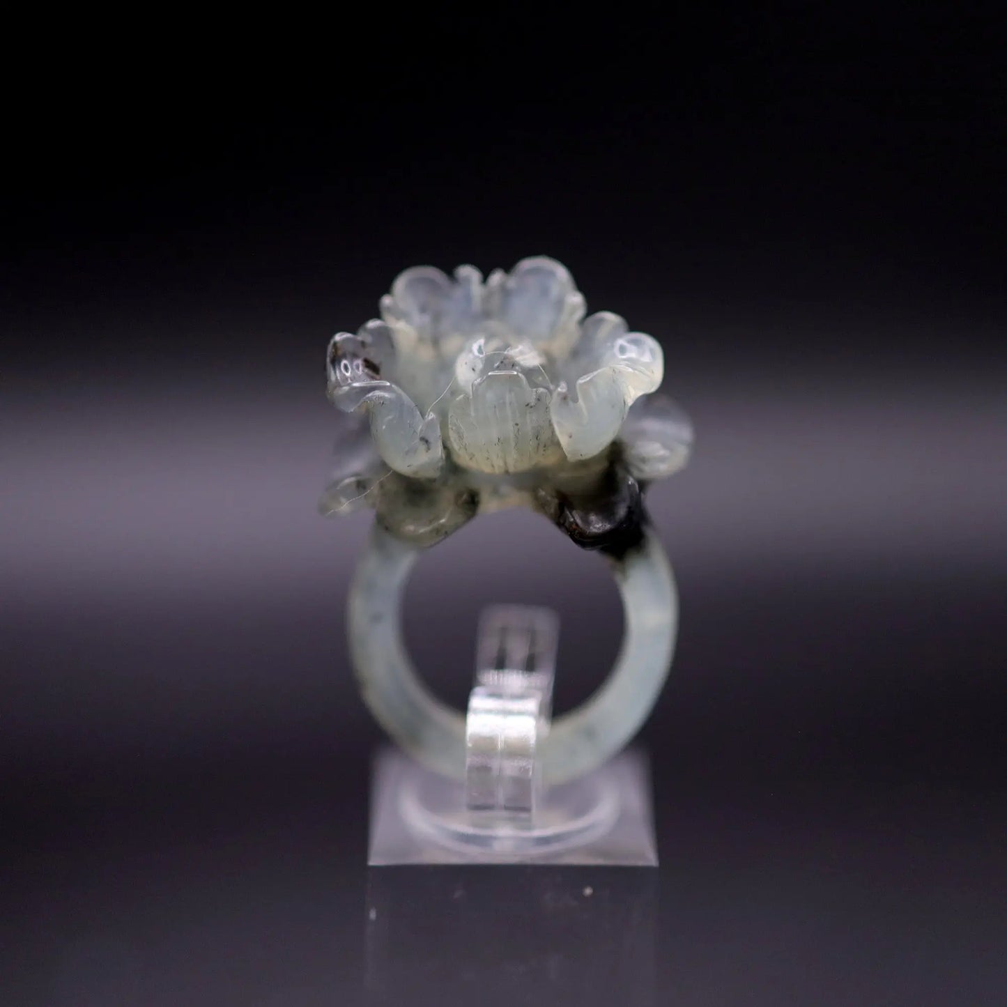 Peony ring carved from translucent serpentine with ink-colored blossoms in full bloom, symbolizing romance and prosperity in sculpted detail.