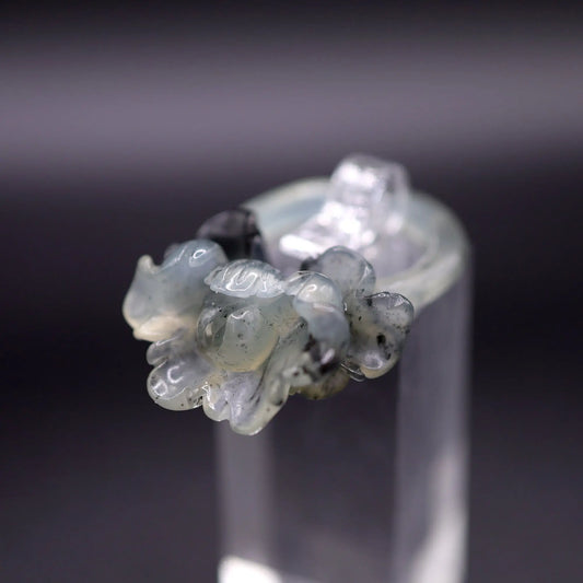 Peony ring carved from translucent serpentine with ink-colored blossoms in full bloom, symbolizing romance and prosperity in sculpted detail.