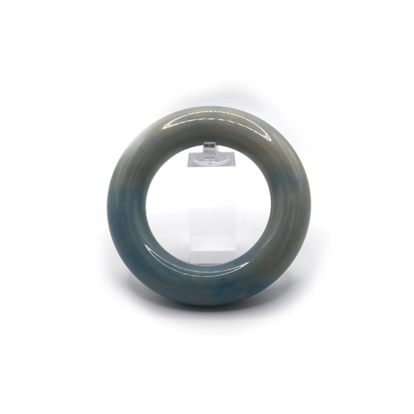 Blue-veined white jade bracelet photographed in soft lighting, highlighting the flowing cloud-like inclusions in serene tones – Miruzi