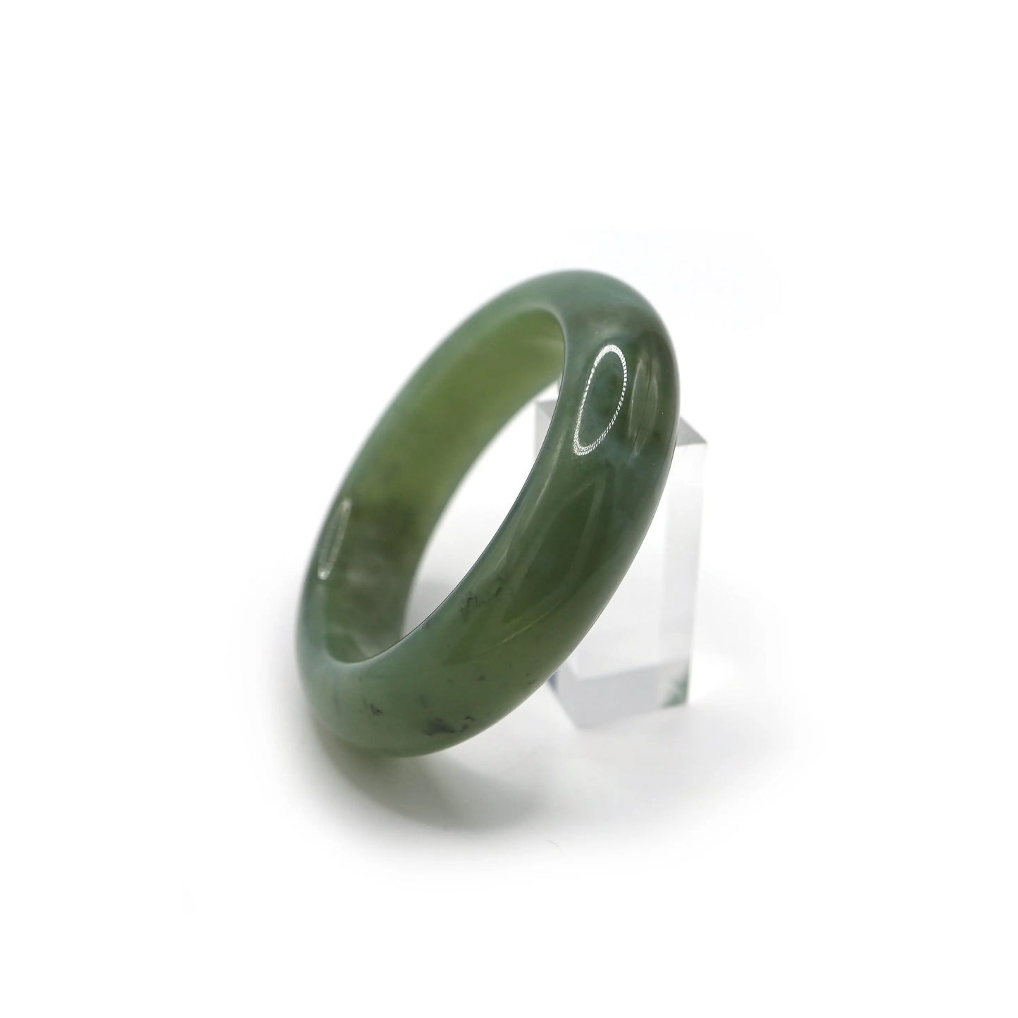 Side view of translucent jade bracelet showing pale green and dark stone inclusions - Miruzi