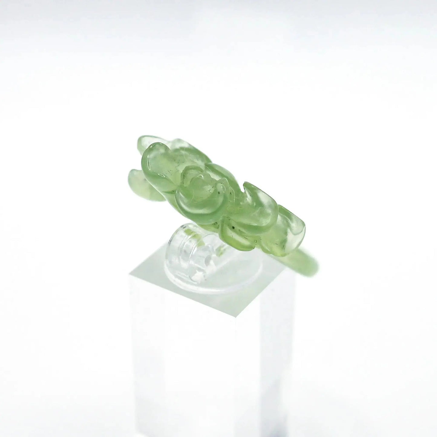 Lotus flower ring hand-carved from serpentine, featuring a soft green lotus bloom atop a clear base—symbolizing purity, peace, and artistic elegance.