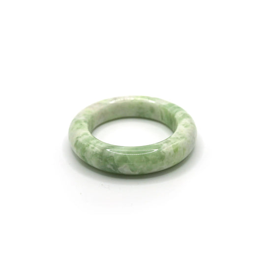 Matcha green jade bracelet with creamy white marbling on soft neutral fabric -Miruzi