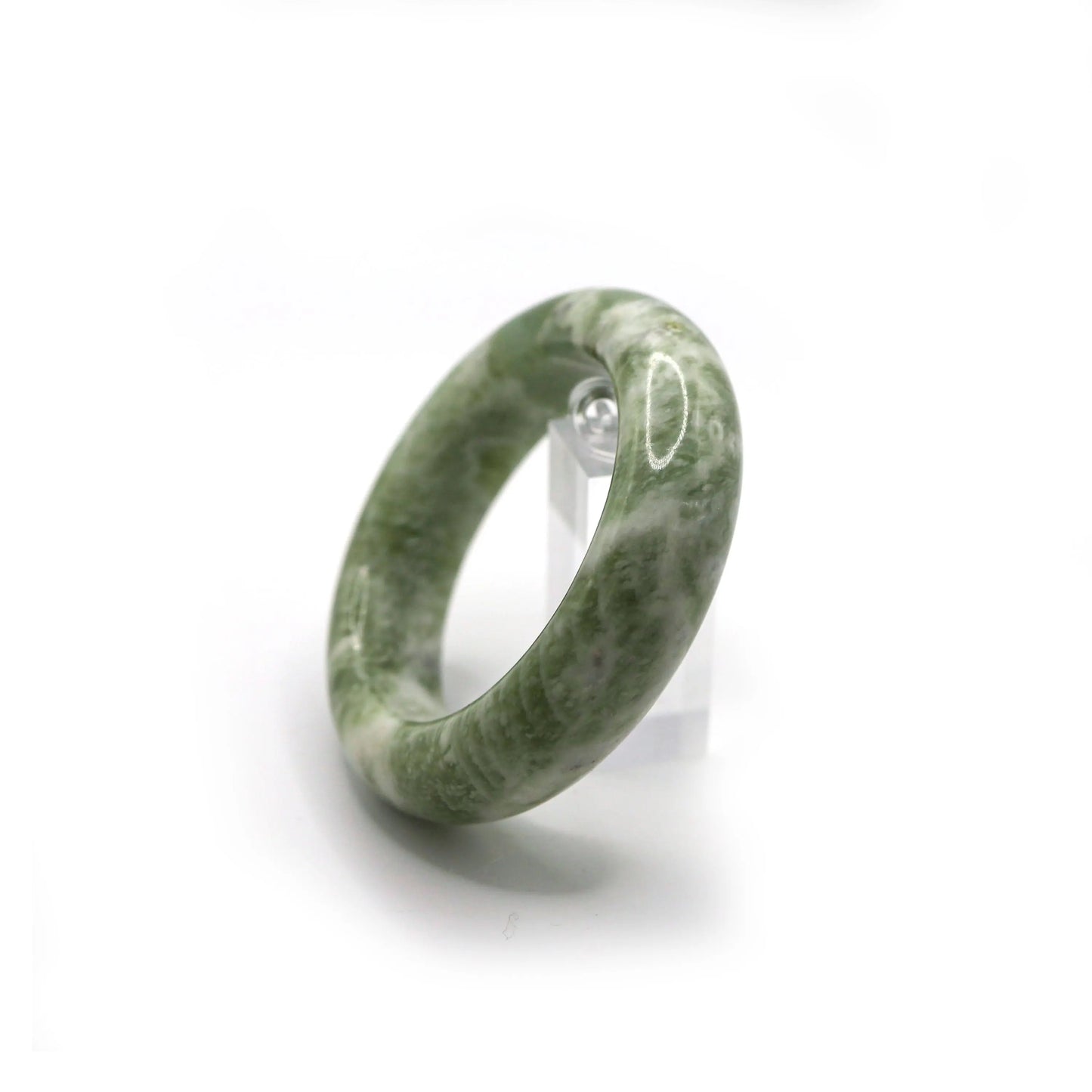 Light green jade bangle styled with ivory knits and pastel tones - Miruzi