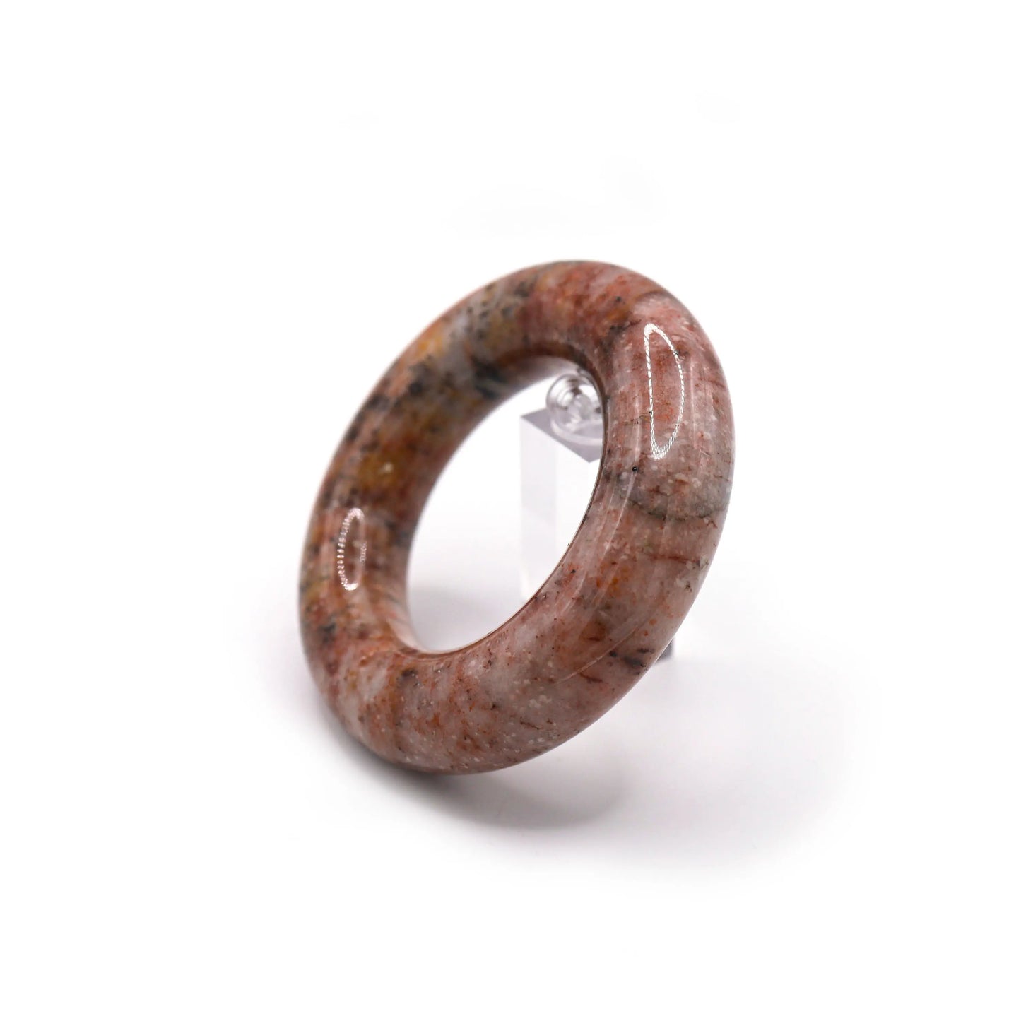 Polished jade bracelet with a swirling mix of red, yellow, black, and white specks set in a blush-pink background – Miruzi