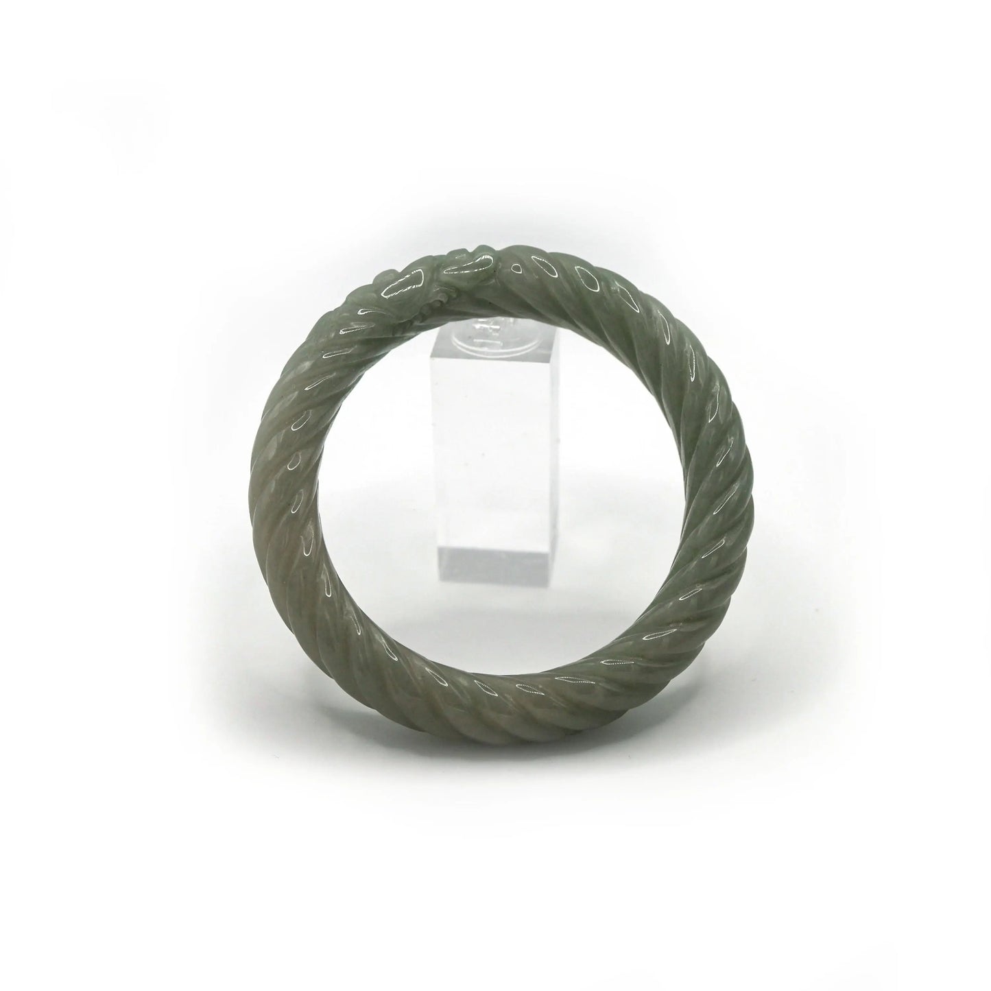 Full green jade bracelet with fluid twist profile and small Yuanbao carvings that bring balance and cultural richness – Miruzi