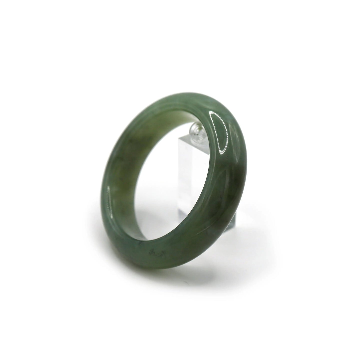 Jade bracelet beside soft-toned silk and dried leaves for calm visual styling - Miruzi