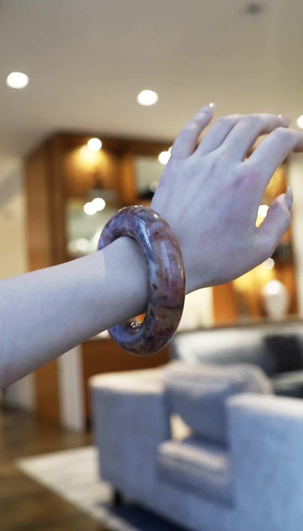 Hand-carved Mongolian quartzite jade bracelet with a soft pink base and natural inclusions of red, orange, yellow, white, and black like brushstrokes in stone – Miruzi