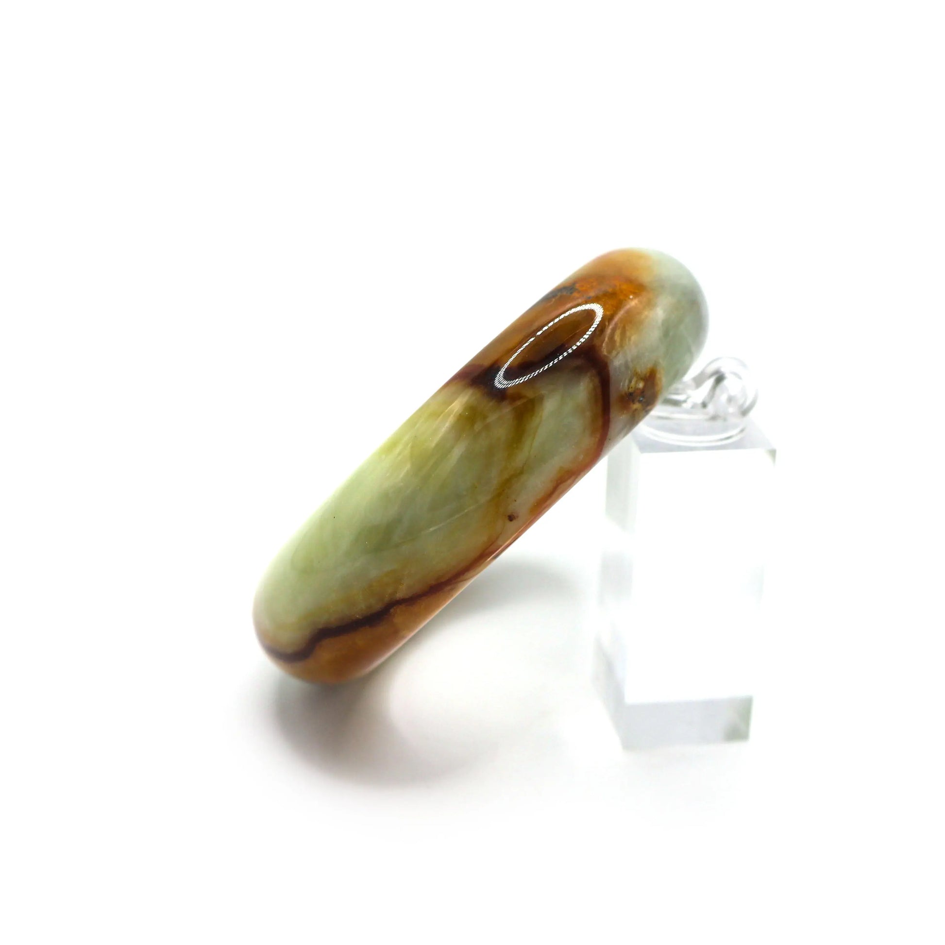 Red vein jade bangle placed in jewelry pouch showing organic stone texture Miruzi
