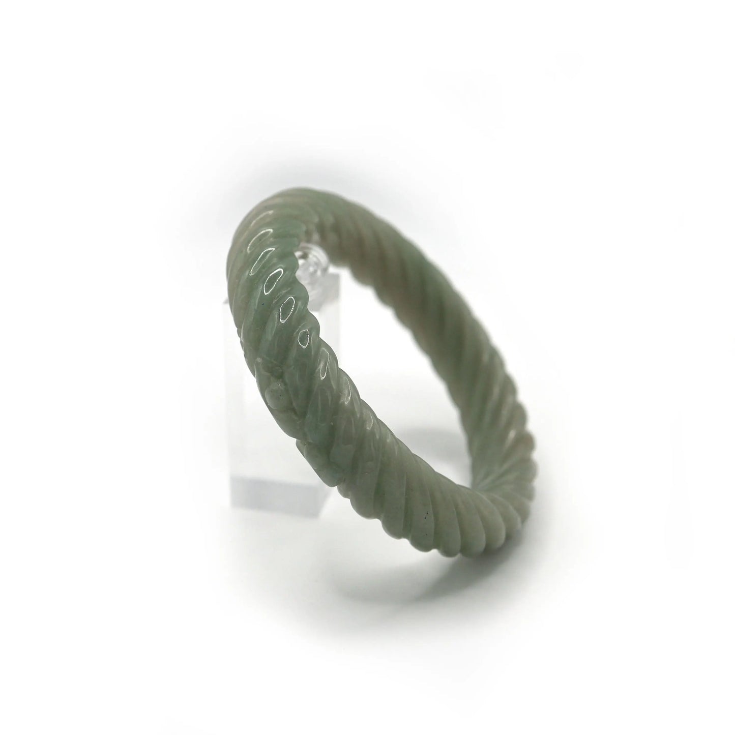 Elegant Mongolian quartzite jade bracelet with a sculptural spiral shape and refined Yuanbao carvings for subtle cultural meaning – Miruzi
