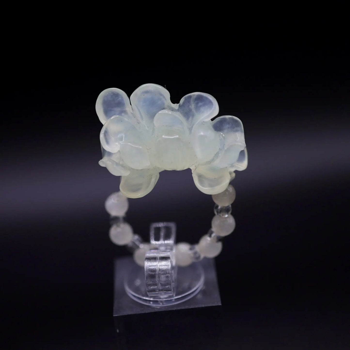 Handcrafted Serene Aqua Peony Adjustable Ring featuring a translucent, ice-clear serpentine base infused with a hint of pale aqua, showcasing a beautifully carved, three-dimensional peony. Perfect for summer, this ring combines ethereal beauty with the art of detailed craftsmanship, ideal for adding a touch of dreamy elegance to any outfit.