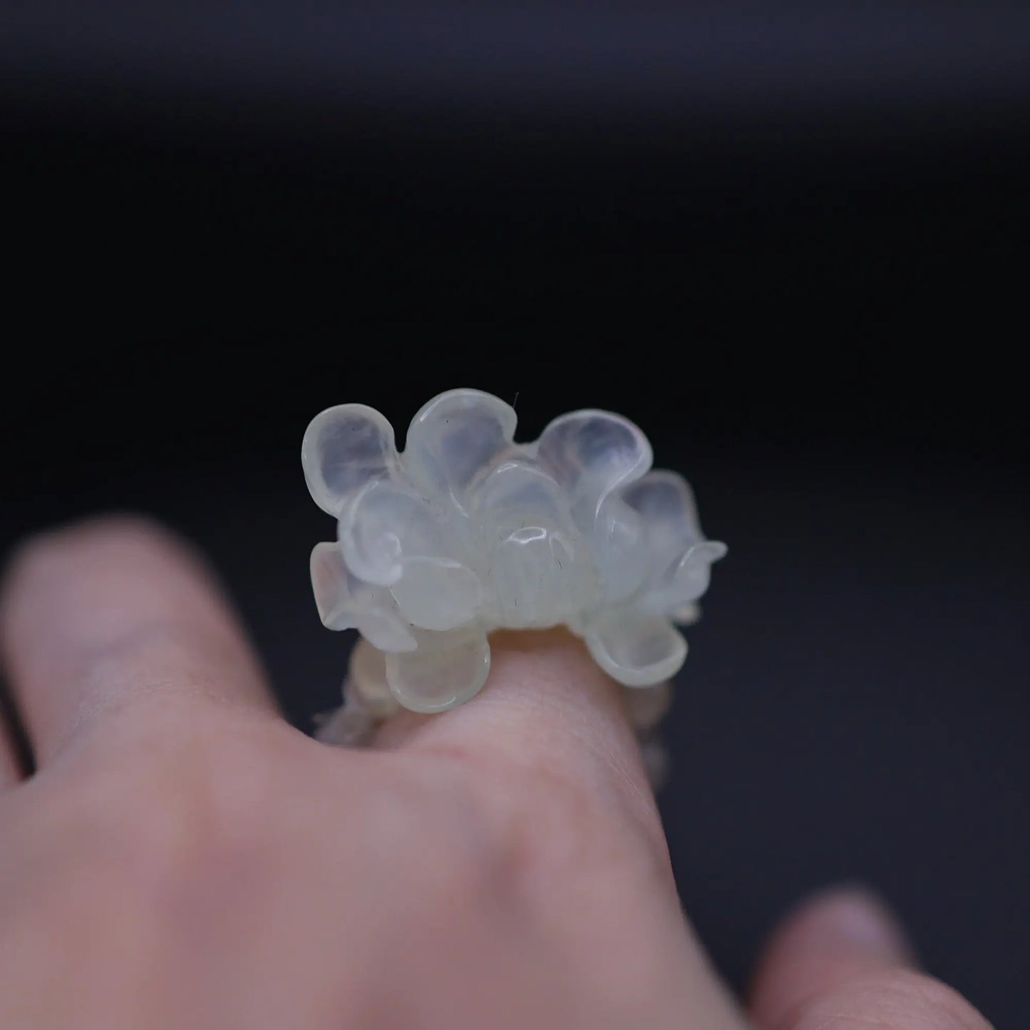 Handcrafted Serene Aqua Peony Adjustable Ring featuring a translucent, ice-clear serpentine base infused with a hint of pale aqua, showcasing a beautifully carved, three-dimensional peony. Perfect for summer, this ring combines ethereal beauty with the art of detailed craftsmanship, ideal for adding a touch of dreamy elegance to any outfit.