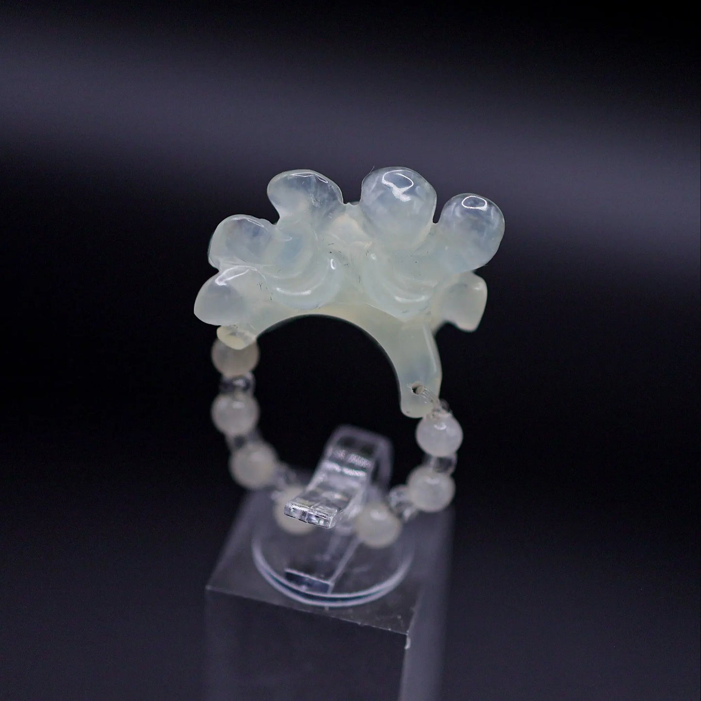 Handcrafted Serene Aqua Peony Adjustable Ring featuring a translucent, ice-clear serpentine base infused with a hint of pale aqua, showcasing a beautifully carved, three-dimensional peony. Perfect for summer, this ring combines ethereal beauty with the art of detailed craftsmanship, ideal for adding a touch of dreamy elegance to any outfit.