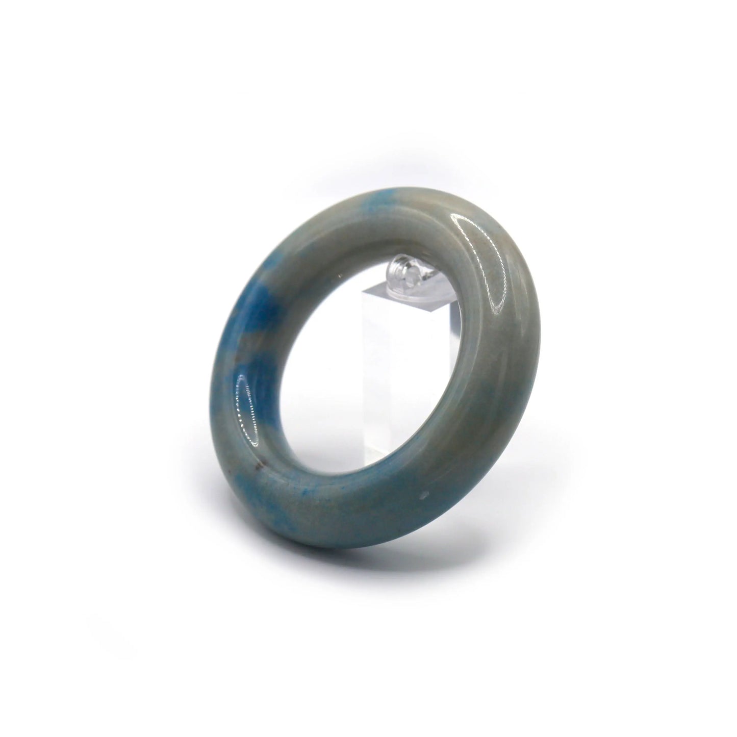 Cream-colored jade bracelet styled on soft cotton, showing cloud-like blue inclusions reminiscent of airy summer skies – Miruzi