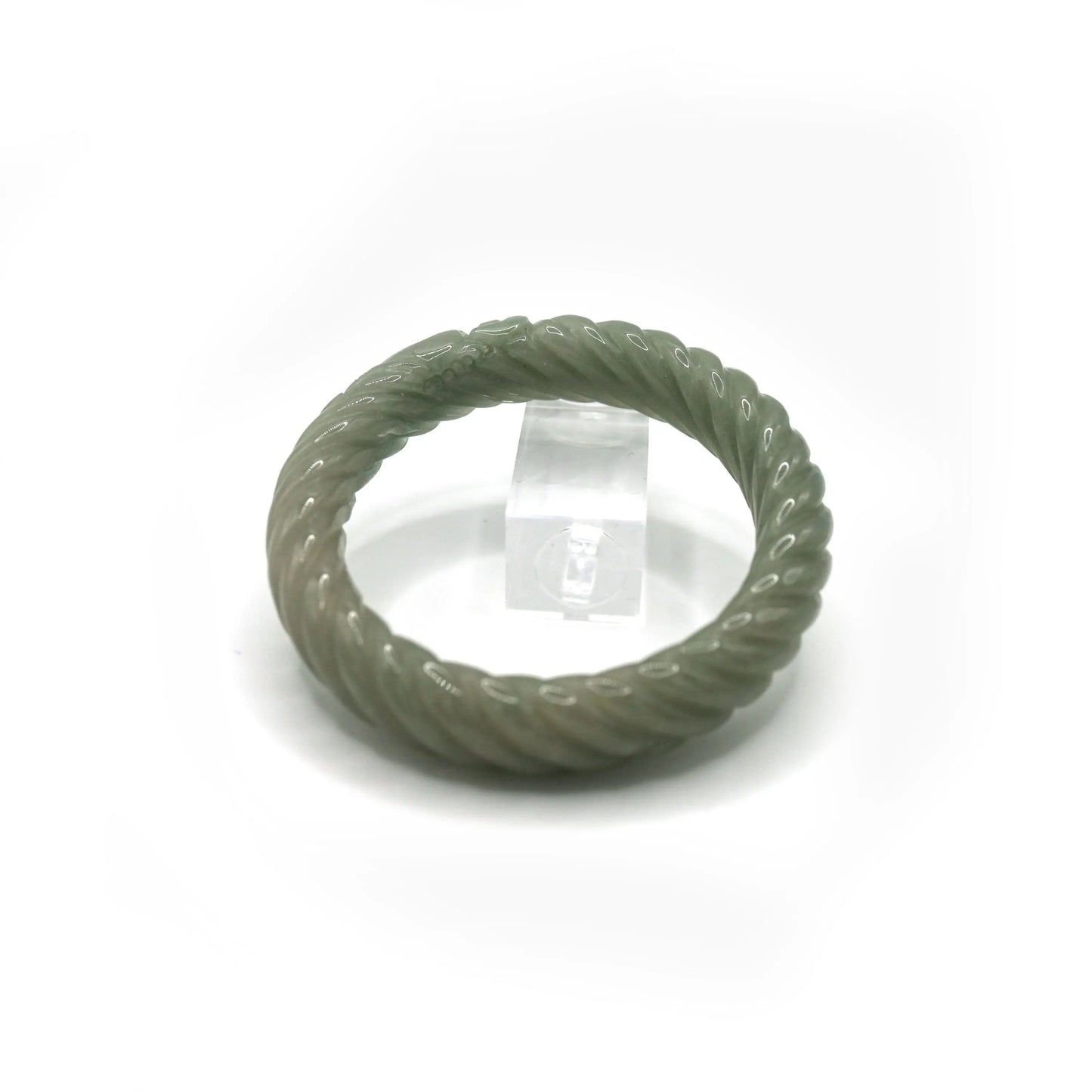 Jade bangle with full-circle twisting motion, crafted in pale green quartzite and adorned with miniature ingot carvings – Miruzi