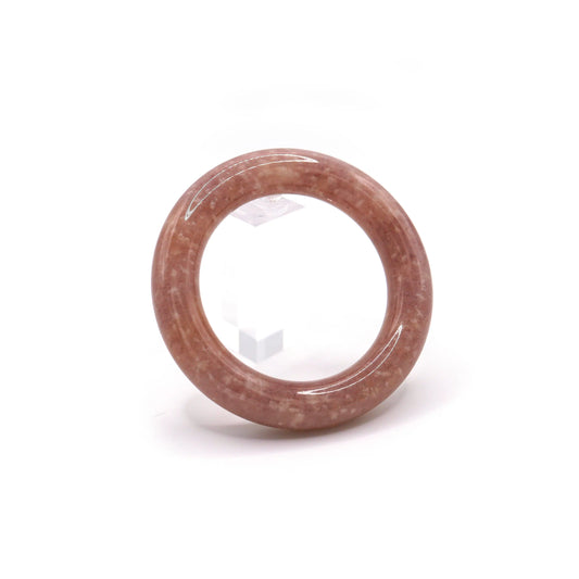 Close-up of pinkish-purple jade bangle with natural white mineral flecks resembling constellations on a twilight-colored stone – Miruzi
